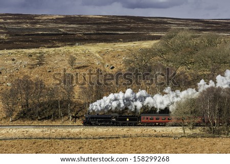 GOATHLAND, UK - MARCH 31: Vintage steam train of the North Yorkshire Moors Railway makes its way through the North York Moors towards Pickering on March 31, 2013 from Goathland, Yorkshire, UK.
