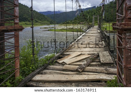 Sangti, Arunachal Pradesh, India. Aging suspension bridge over the river Sangti near Sangti village in western Arunachal Pradesh, north east India.