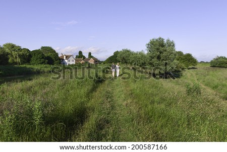 BEVERLEY, UK - JUNE 23: Ramblers use footpath along the bank of the river Hull on a fine summer day on June 23, 2014 near Beverley, Yorkshire, UK.