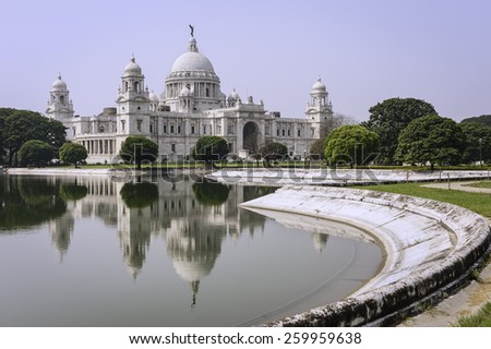 Kolkata, India - The Victoria Memorial on a bright sunny morning with blue sky with reflections of the memorial in the water feature to the front of the monument.