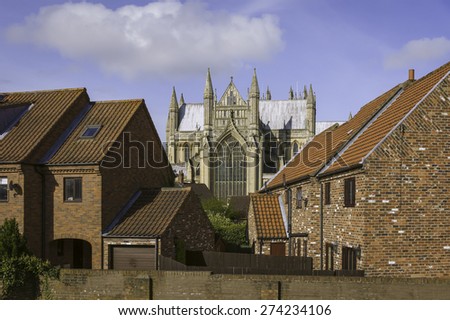 Beverley, Yorkshire, UK. 13th Century Beverley Minster and town houses on a bright spring morning in the heart of the market town of Beverley, Yorkshire, UK.