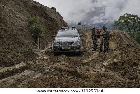 DIRANG, INDIA - SEPTEMBER 19, 2011: Indian army rescue stuck in mud during construction of main highway between Assam and Tawang on September 19, 2011 near Dirang, Arunachal Pradesh, India.