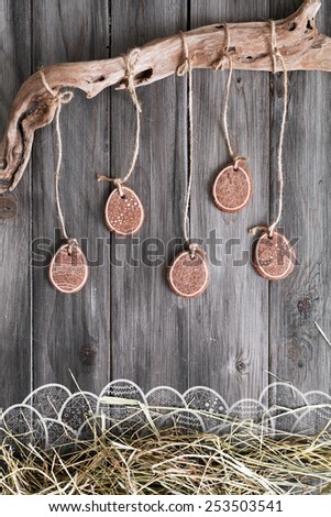 Easter cookies on dark background boards and straw
