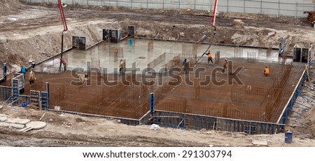 Construction of the building. Pouring the concrete foundation slab foundation. The concrete base slab foundation under the building. Stages of construction of the building. Foundation plate and
