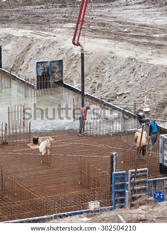 Construction of the building. Pouring the concrete foundation slab foundation. The concrete base slab foundation under the building. Stages of construction of the building.
