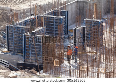 Monolithic frame construction of the building. Solid walls of concrete. The framework for the walls. Formwork for walls made of concrete. Construction of the building.