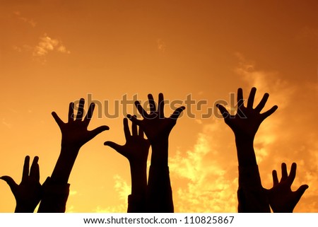 Hands up at sunset