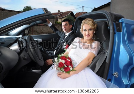 Wedding couple portrait in sport car