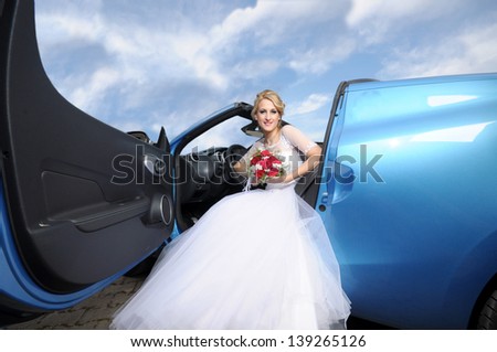 Lovely bride sitting in sport car
