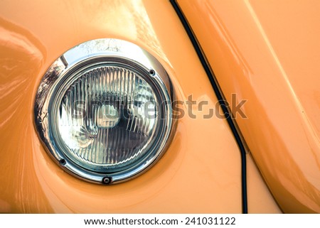 Retro car headlight closeup , orange old car closeup