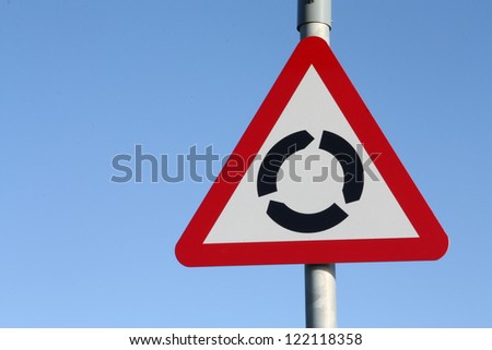 Traditional British roundabout road warning sign