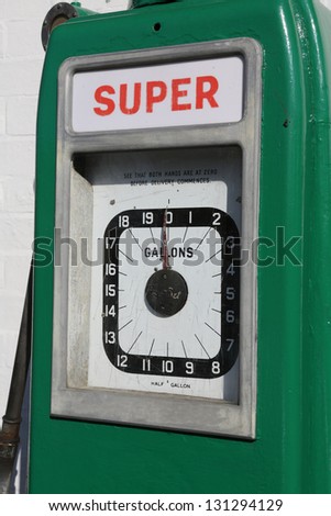 Close up of the dial of an old gas/petrol pump near an old garage.