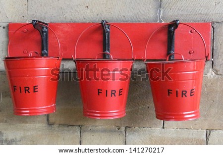 Three fire buckets hanging on a wall