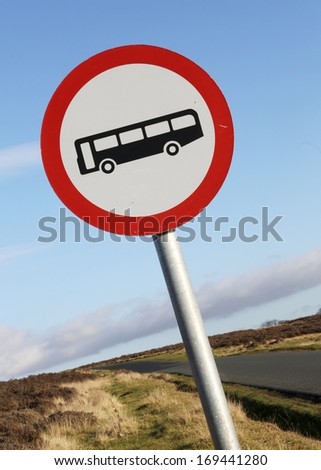 No buses allowed sign on a narrow moorland road