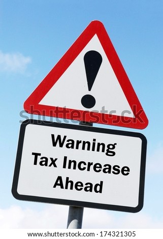 A red and white road sign depicting a warning about an increase in taxes ahead.