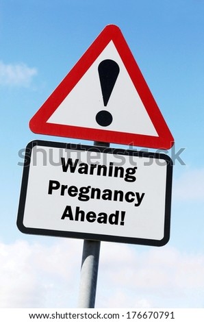 Red and white triangular warning road sign with a pregnancy ahead concept against a partly cloudy sky background
