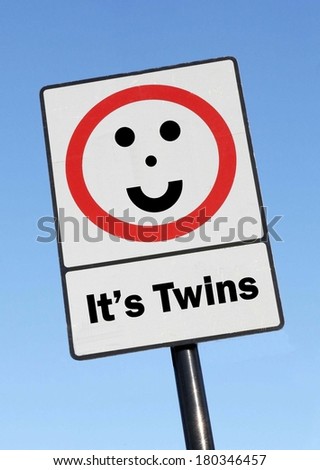 A road traffic sign with an It\'s Twins concept with a clear blue sky background.