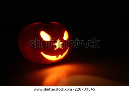 Carved Halloween pumpkin  with smile, joke teeth, cut eyes, mouth and nose hole