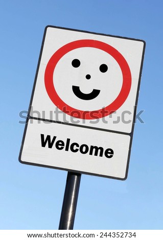 A road traffic sign with a Welcome concept with a clear blue sky background.