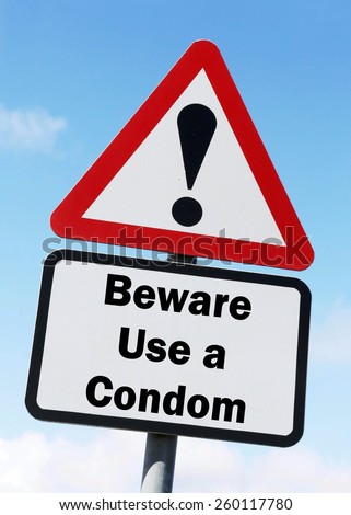 Red and white triangular warning road sign with a warning to Use a Condom ahead concept against a partly cloudy sky background