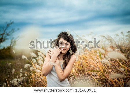 trees, background, girl, thoughtfulness, joy, fall, heat, beauty, clothes, nature, ears, fluffy, dry grass,