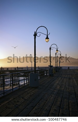 Lampposts on the Santa Monica Pier in California at sunset.