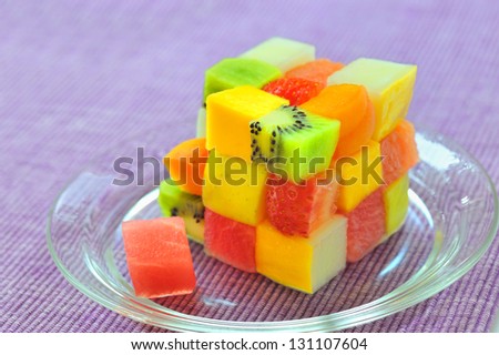 cube fruits salad on lilac background