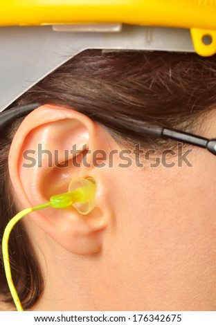 Woman with protective equipment and ear plugs