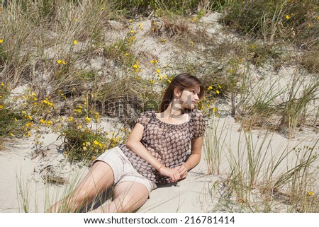 Young beautiful woman lying on the sand and enjoy your vacation