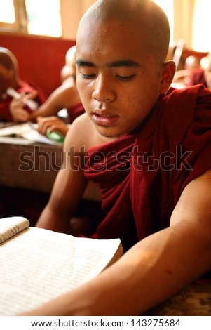 YANGON - MYANMAR - DECEMBER 6, 2012: An unidentified Burmese Buddhist novice on December 6, 2012 in Yangon, Myanmar. In 2012 an ongoing conflict started between Buddhists and Muslims in Myanmar.