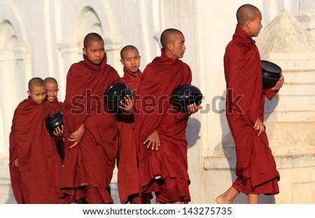 NYAUNGSHWE - MYANMAR - DECEMBER 26, 2012: Unidentified Burmese Buddhist monks on December 26, 2012 in Nyaungshwe, Myanmar. In 2012 an ongoing conflict started between Buddhists and Muslims in Myanmar