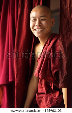 AMARAPURA - MYANMAR - DECEMBER 14: An unidentified Burmese monk on December 14, 2013 in Amarapura, Myanmar. In 2012 an ongoing conflict started between Buddhists and Muslims in Myanmar.