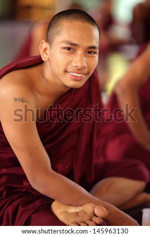 YANGON - MYANMAR - DECEMBER 4: An unidentified young Burmese monk on December 4, 2013 in Yangon, Myanmar. In 2012 an ongoing conflict started between Buddhists and Muslims in Myanmar.