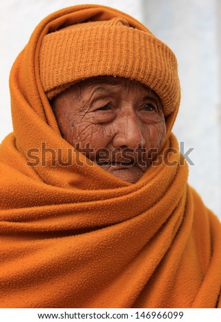 NYAUNGSHWE - MYANMAR - DECEMBER 18: Unidentified Burmese Buddhist monk on December 18, 2012 in Nyaungshwe, Myanmar. In 2012 an ongoing conflict started between Buddhists and Muslims in Myanmar