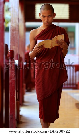 MANDALAY - MYANMAR - DECEMBER 14: An unidentified Burmese Buddhist monk on December 14, 2012 in Mandalay, Myanmar. In 2012 an ongoing conflict started between Buddhists and Muslims in Myanmar.