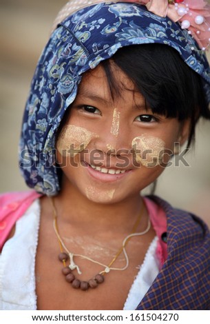 Mandalay - Myanmar - December 8, 2012: An Unidentified Smiling Burmese Girl On December 8, 2012 In Mandalay, Myanmar. In 2012 An Ongoing Conflict Started Between Buddhists And Muslims In Myanmar.