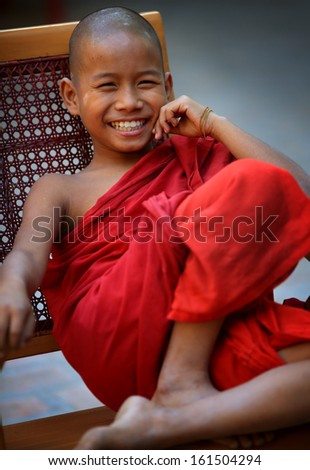 MANDALAY - MYANMAR - DECEMBER 15, 2012: Unidentified smiling Buddhist novice on December 15, 2012 in Mandalay, Myanmar. In 2012 an ongoing conflict started between Buddhists and Muslims in Myanmar.