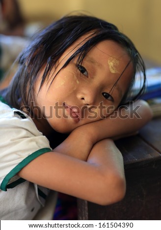 YANGON - MYANMAR - DECEMBER 4, 2012: Unidentified Burmese student at school on December 4, 2012 in Yangon, Myanmar. In 2012 an ongoing conflict started between Buddhists and Muslims in Myanmar.