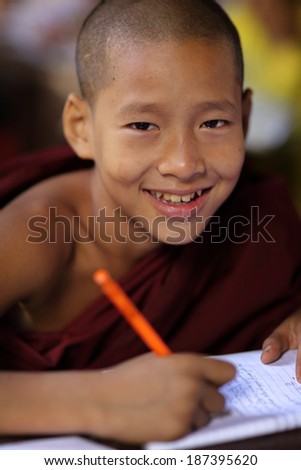 MANDALAY - MYANMAR - DECEMBER 15, 2013: An unidentified Burmese Buddhist novice on December 15, 2013 in Mandalay, Myanmar. In 2012 an ongoing conflict started between Buddhists and Muslims in Myanmar.