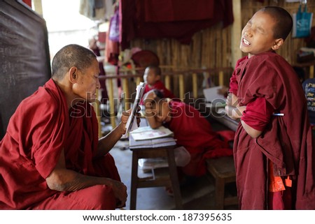 MANDALAY - MYANMAR - DECEMBER 22, 2013: An unidentified Buddhist monk and novice on December 22, 2013 in Mandalay, Myanmar. In 2012 an ongoing conflict started between Buddhists and Muslims in Myanmar