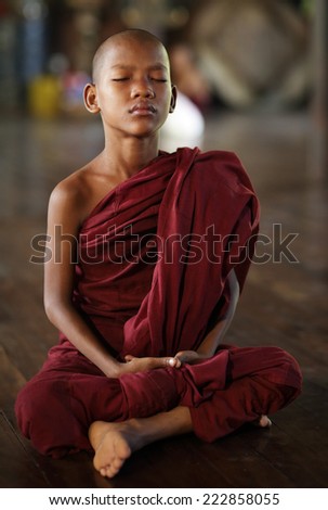 YANGON - MYANMAR - DECEMBER 3, 2013: An unidentified Burmese novice on December 3, 2013 in Yangon, Myanmar. In 2012 an ongoing conflict started between Buddhists and Muslims in Myanmar.