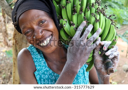 UKEREWE ISLAND - TANZANIA - JULY 4, 2015: Unidentified woman carrying bananas on July 4, 2015 in a rural village on Ukerewe Island, Lake Victoria, Tanzania