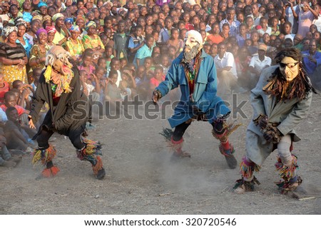 MITUNDU - MALAWI - JULY 30, 2015: Unidentified traditional Nyau dancers with face masks at a Gule Wamkulu ceremony on July 30, 2015 in the traditional village Mitundu near Lilongwe, Malawi