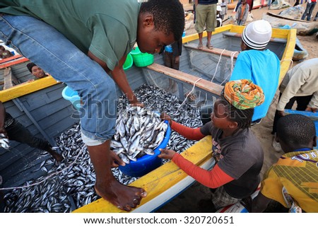 LAKE MALAWI - MALAWI - AUGUST 6, 2015: Unidentified fishermen and market women trading fish on August 6, 2015 in the village Cape Maclear at Lake Malawi, Malawi