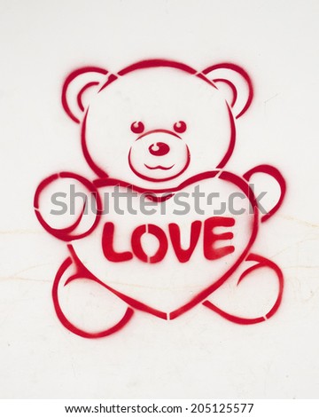 Preview bears with hearts drawn on the wall with red paint