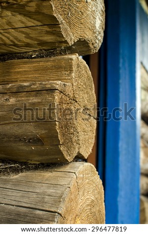 Log cabin of an old house in the village and a large species of logs in diameter