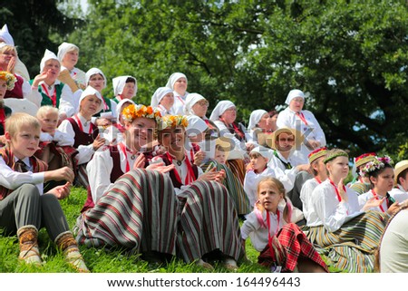 RIGA, LATVIA - JULY 06: People in national costumes at the Latvian National Song and Dance Festival on July 06, 2013. Holiday was hold from 30th June 2013 to 7th July 2013.