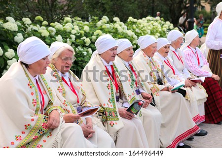 RIGA, LATVIA - JULY 06: People in national costumes at the Latvian National Song and Dance Festival on July 06, 2013. Holiday was hold from 30th June 2013 to 7th July 2013.