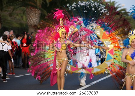 LANZAROTE, SPAIN - March 14: Women and man in costumes march at the Grand Carnival Parade in Costa Teguise, on March 14, 2009. Lanzarote, Canaries islands, Spain.