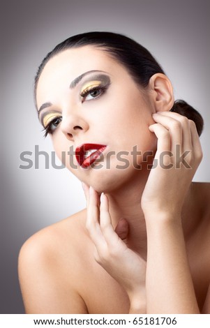 beautiful woman over grey background with beautiful makeup